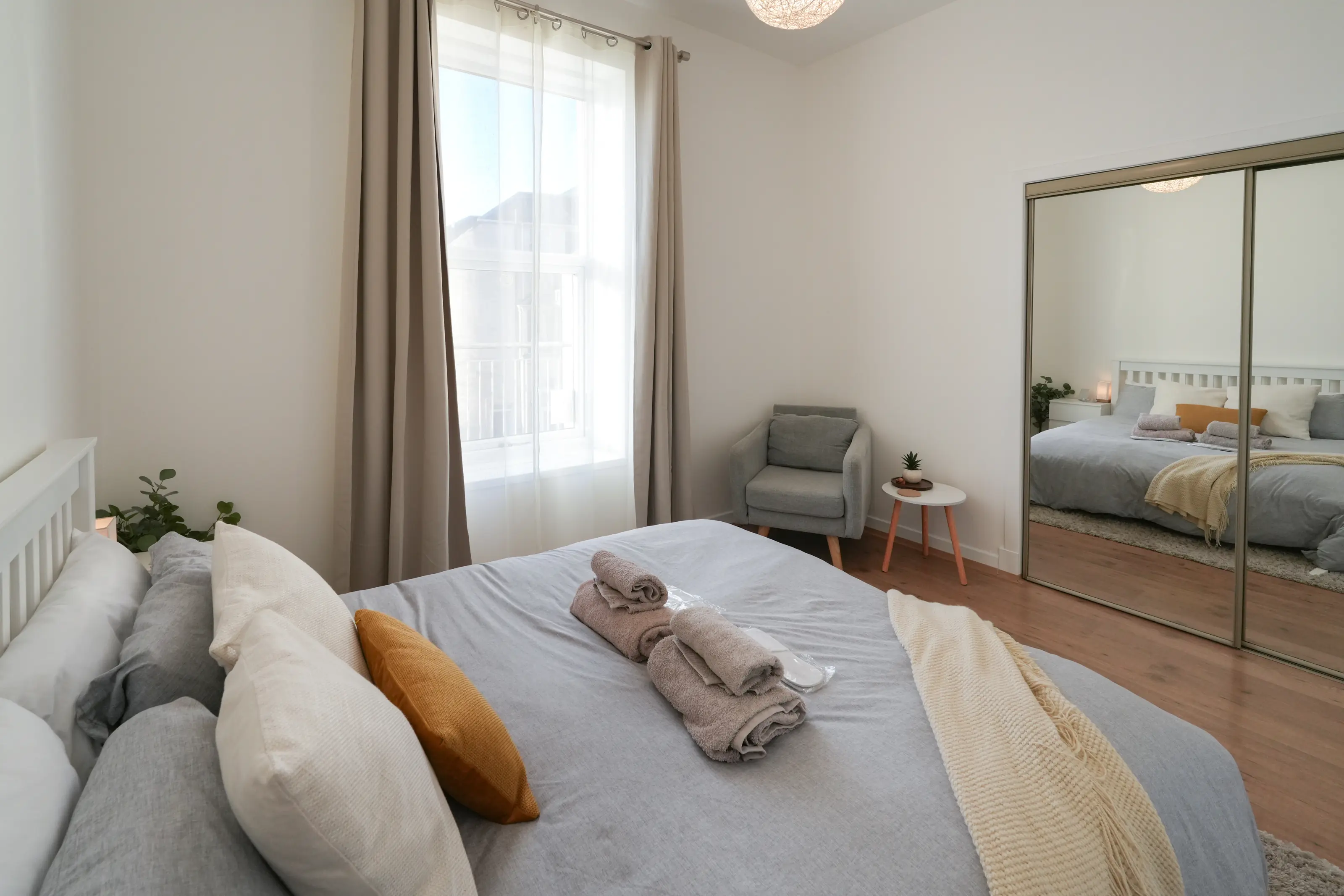 Quiet king-size bedroom with premium bedding and natural light