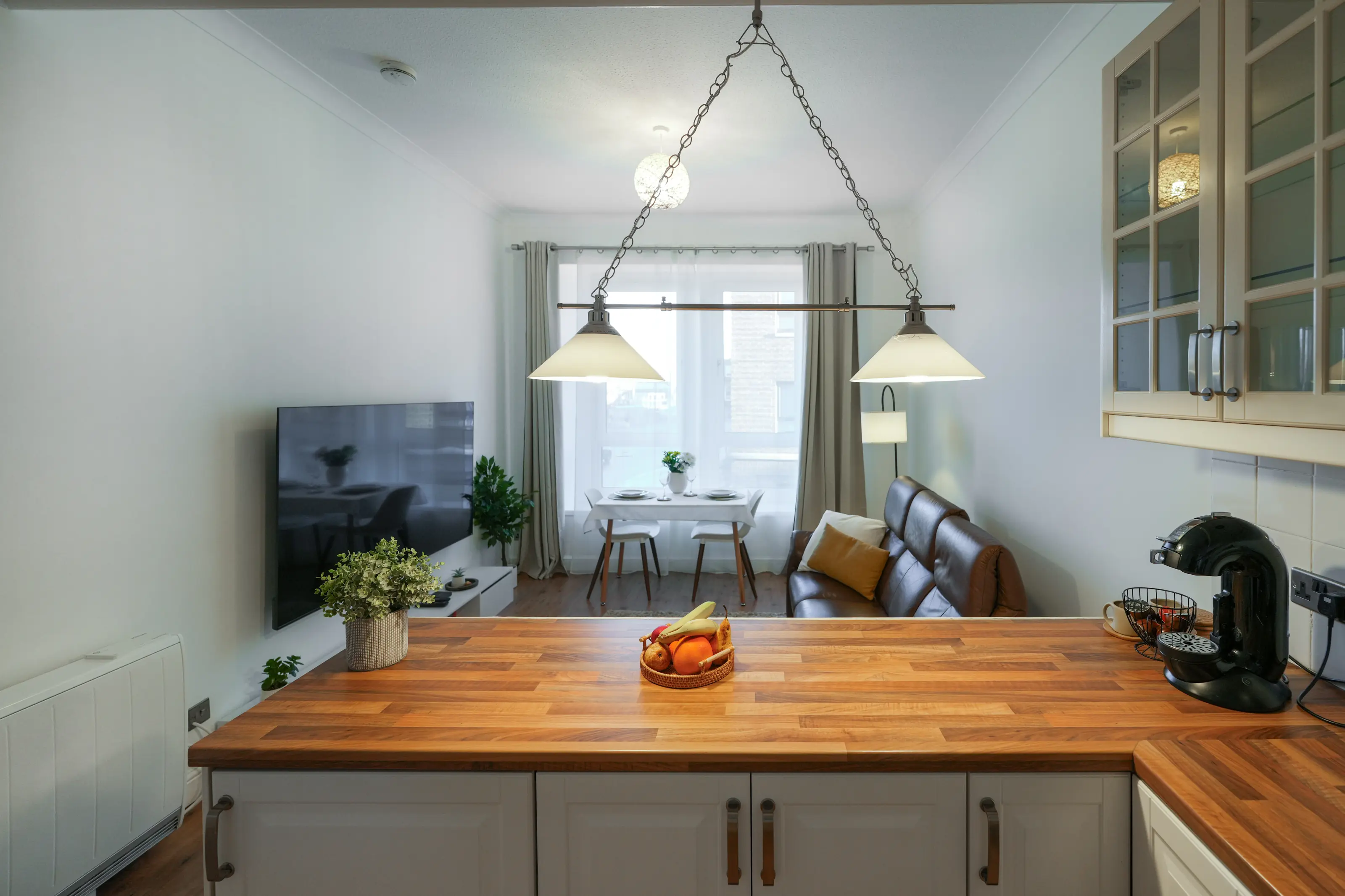 Open-plan living space with dining table beside the kitchen